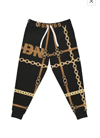 a black and gold sweatpants with chains on them